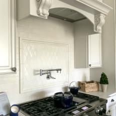 Custom Cabinets and Backsplash Add Elegance While Double Ovens and Gas Stove Ensure Functionality