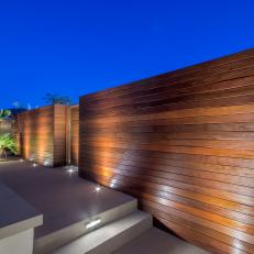 Contemporary Concrete Walkway With Rich Wood Wall