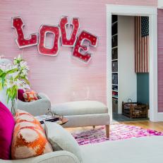 Pink Sitting Area With "Love" Light Fixture