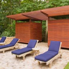 Contemporary Pool Deck with Slatted Wood Cabanas 