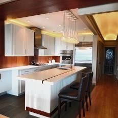 Brown and White Kitchen With Leather Barstools