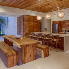 Wood-Paneled Kitchen and Dining Room With Wood Table