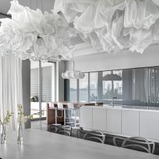 White Modern Dining Room With Cloud Pendants