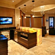Contemporary Wet Bar With Sleek Wood Cabinets & Warm Lighting