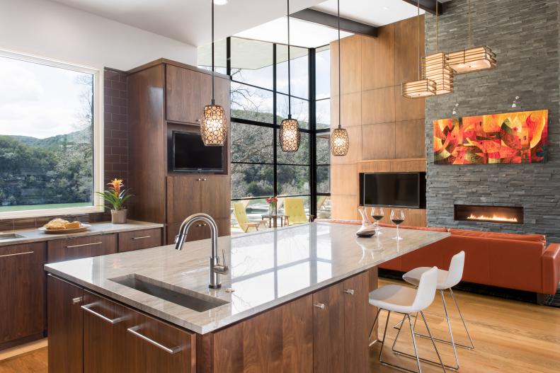 Contemporary Kitchen With Brown Cabinets & Living Room With Fireplace