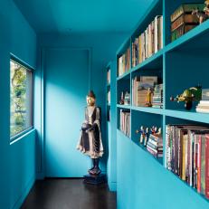 Bold Aqua Hallway With Built-In Bookshelves