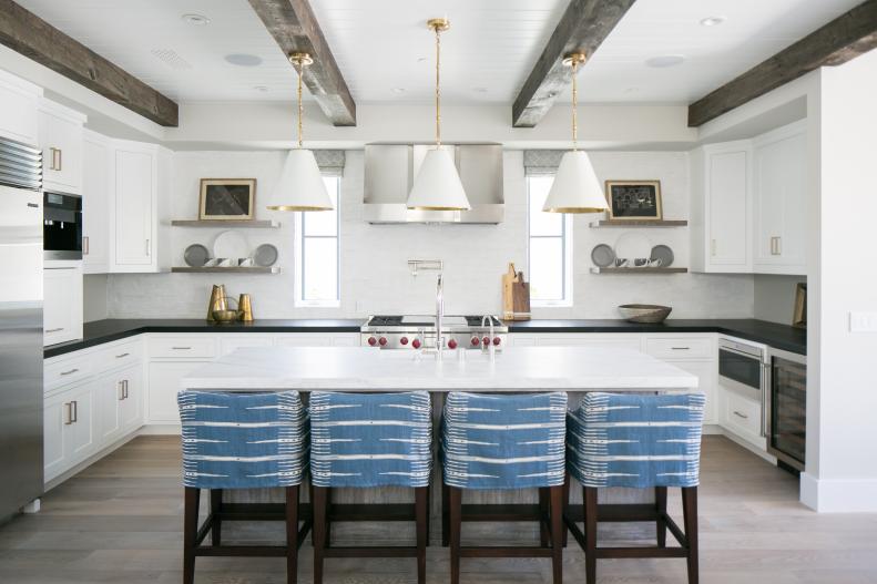 Transitional White Kitchen With Wood Ceiling Beams and White Pendants