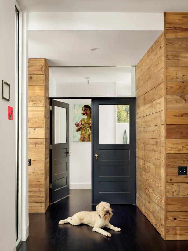 Master Suite with Antique Black Doors, Wood Walls, Dark Hardwood