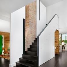Modern Staircase with Exposed Brick Chimney