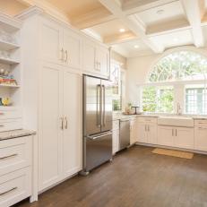 Stunning White Kitchen Features Farmhouse Sink, Coffered Ceiling & Sophisticated Cabinets