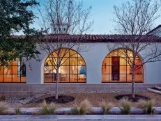 White Spanish Revival Home with a Row of Steel Windows