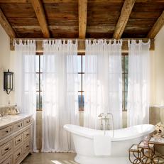 Mediterranean Master Bath with Exposed Wood Ceilings