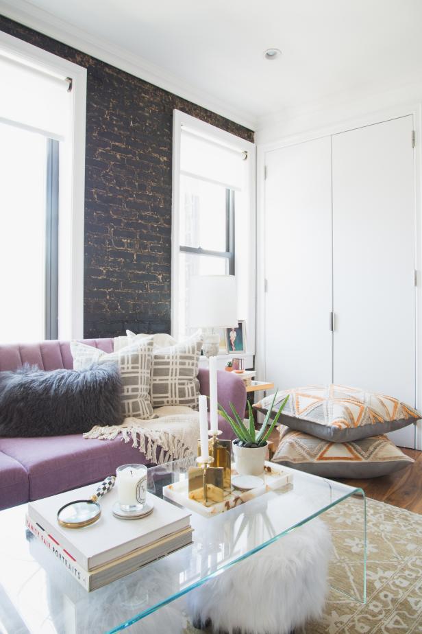 White Living Area With Black Brick Accent Wall and Purple Sofa