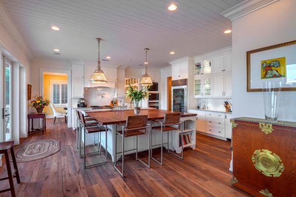 Kitchen With White Cabinets, Wood Floors and Wood-Topped Island