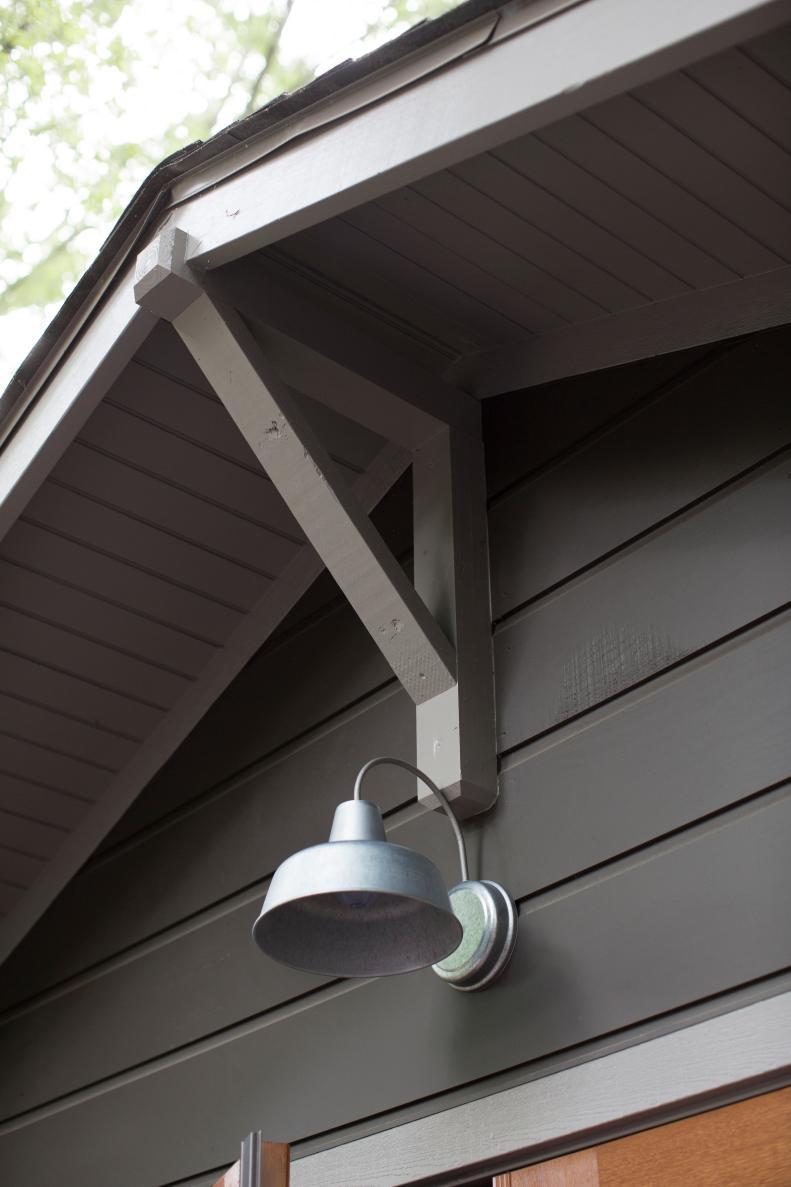 A galvanized outdoor light brightens the deck for cozy evening gatherings.