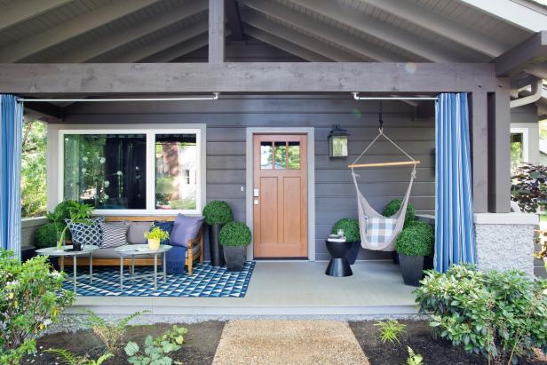 “The front porch is about 8 feet deep by roughly 20 feet wide,” says interior designer Brian Patrick Flynn. “It’s enough to function as an outdoor room.” An all-weather rug, teak sofa and colorful coffee table carve out the conversation area. 