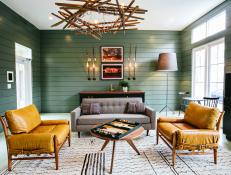 Rustic Green Living Space With Mustard Yellow Chairs and Gray Sofa