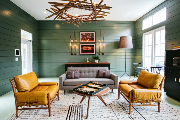 Rustic Green Living Space With Mustard Yellow Chairs and Gray Sofa