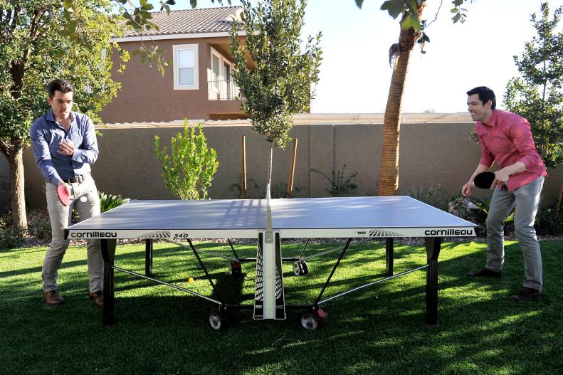 As seen on Brother vs. Brother, Jonathan (L) and Drew Scott play ping pong at their Las Vegas home while waiting the return and the final decision from guest judges realtor David Visentin and designer Hilary Farr on which brother won the bedroom and bathroom challenge.  The winning brother gets to watch the other perform a humiliating dare which included eating 20 hot wings and having a bucket of hot sauce poured over him.
