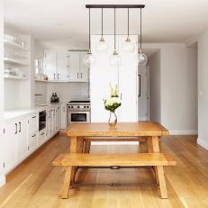 White Penthouse Kitchen With Globe Pendant Light Fixture