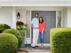 homeowners in front of ranch-style home