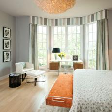 Contemporary Guest Room Features Bold Orange Accents