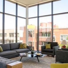 Living Room With Floor To Ceiling Windows And Gray Furniture
