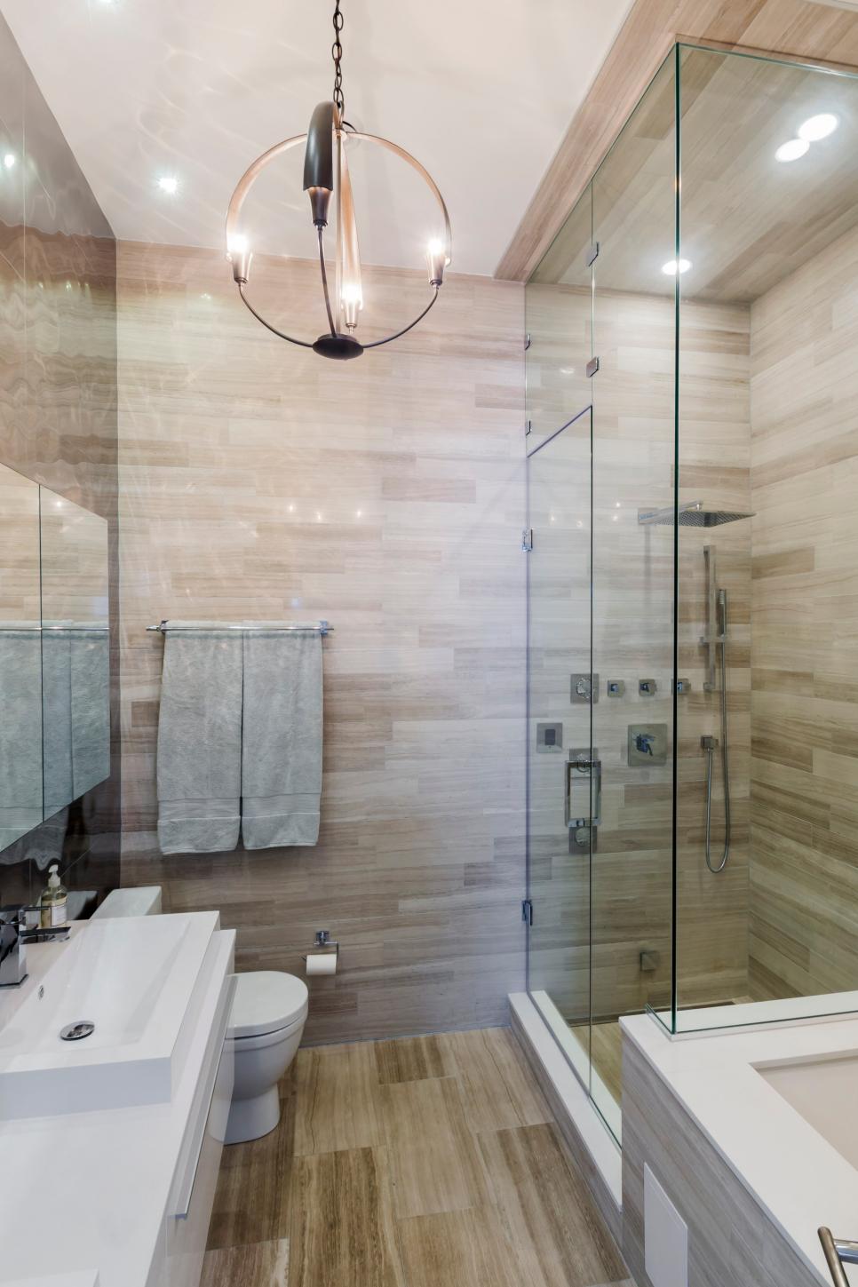 Modern Luxury Stone Bathroom With Unique Pendant Light | HGTV