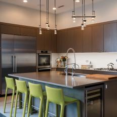 Streamlined Modern Kitchen With Large Kitchen Island And Chartreuse Stools