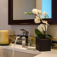 Neutral Bathroom With Glass Tile Feature And Modern Faucet