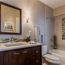 Neutral Toned Modern Bathroom With Glass Tile Detailing