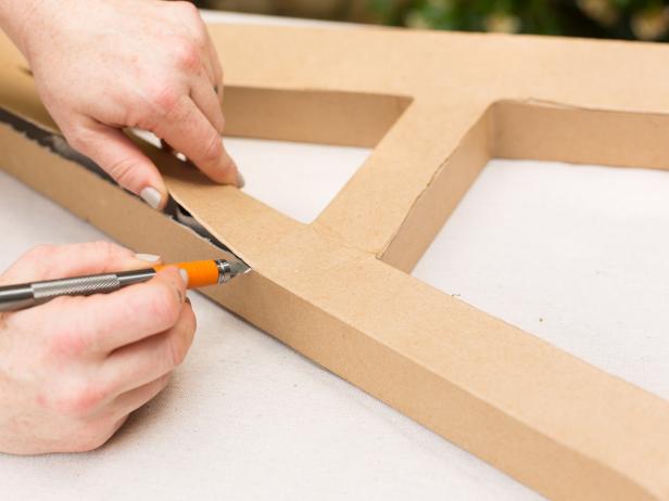 Using a craft knife, cut along the outside edge of the letter to remove the front.