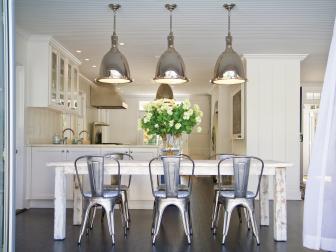 Open Kitchen With Distressed Table, Metal Chairs & Floral Centerpiece