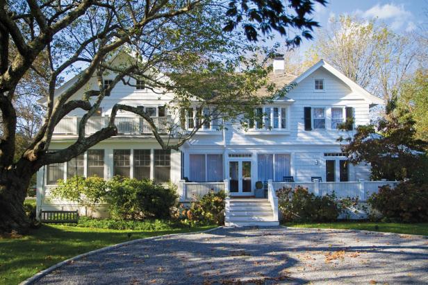 Exterior of Black & White Home With Swing in Tree