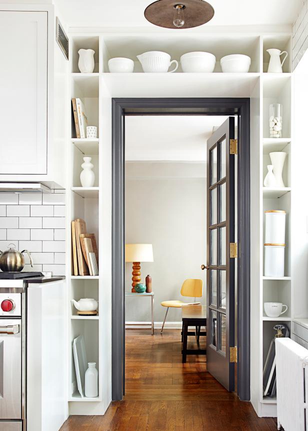 Built-In Shelving Around Doorframe With White Kitchen Ware