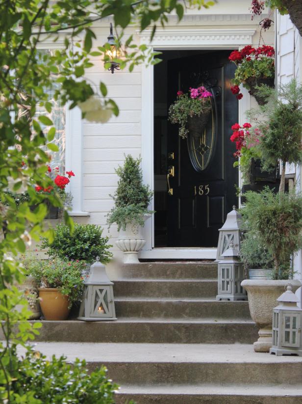Cottage Black Front Door with Red and Hot Pink Geraniums