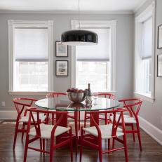 Chic, Contemporary Dining Area Features Bold Red Chairs