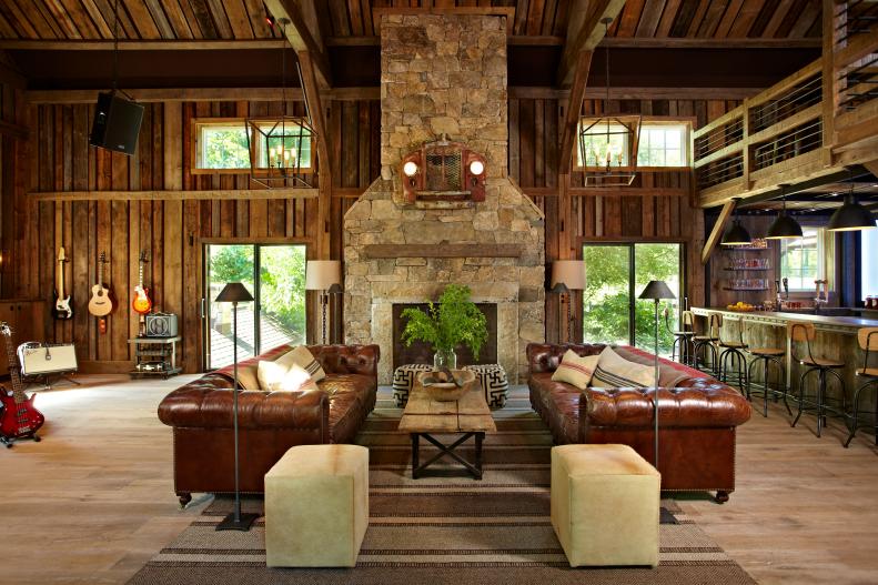 Rustic Barn With Reclaimed Wood Walls, Stone Fireplace & Brown Sofas