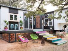 Two trailers were connected to create a tiny home that lives larger than its footprint. Color and a mix of styles gives the home a bohemian feel, while a spacious porch is perfect for entertaining under the Texas sky.