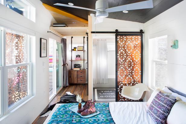 Small White Eclectic Bedroom With Copper Panel Door & Storage Rack