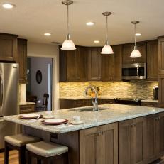 Open Plan Contemporary Kitchen Featuring Built In Stainless Steel Appliances