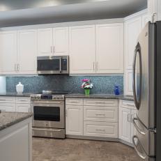 Transitional Kitchen With White Cabinetry and Tile Floor