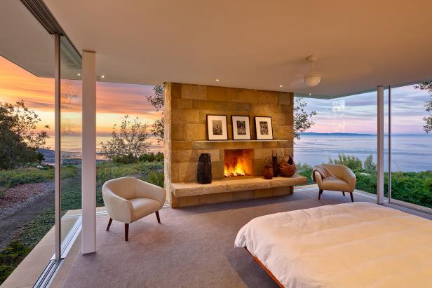 Modern Master Bedroom With Glass Walls And Stone Fireplace