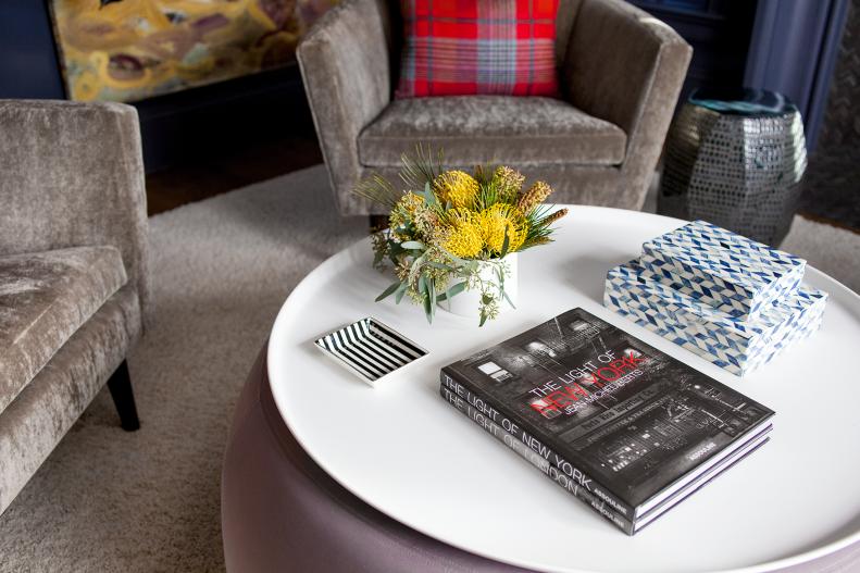 Round Coffee Table in Navy Blue Sitting Area With Gray Velvet Chairs