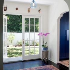 Eclectic Hallway with French Doors and Blue Pendant Light