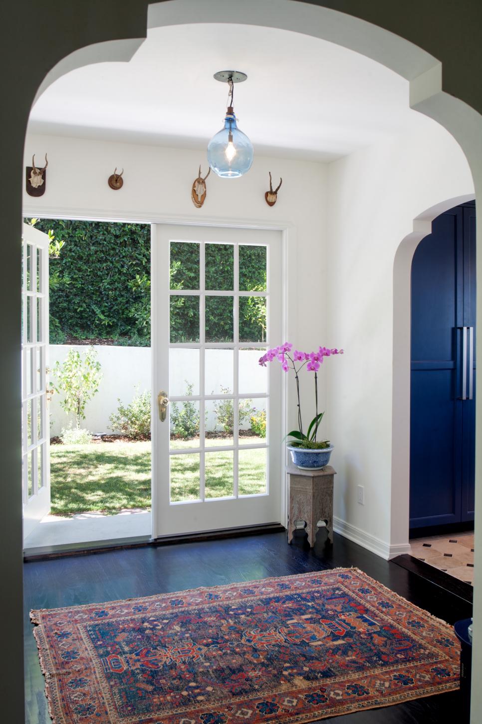 Eclectic Hallway with French Doors and Blue Pendant Light | HGTV