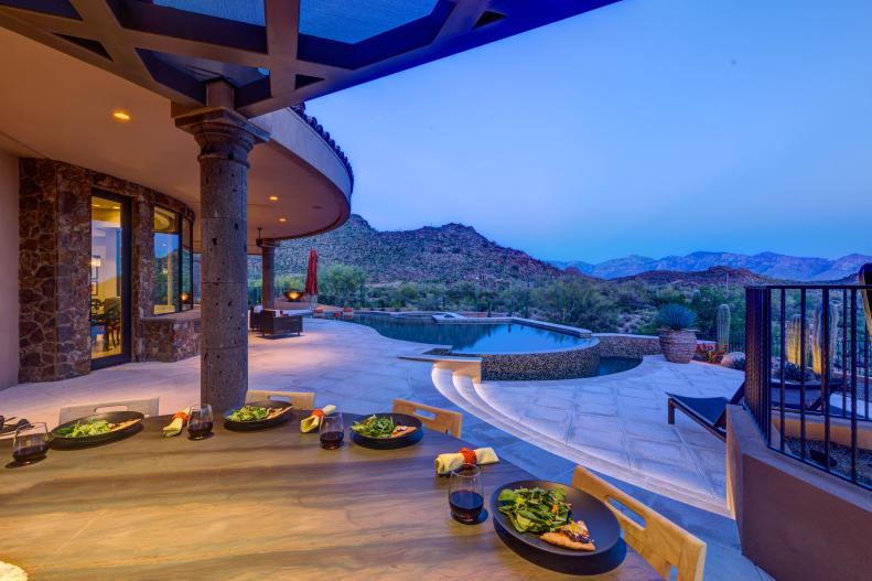 Round Outdoor Dining Table Overlooking Mountains & Infinity Pool
