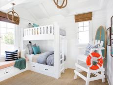 Coastal White Kids' Bedroom With White Bunk Beds and Lifeguard Chair