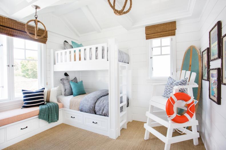 Coastal White Kids' Bedroom With White Bunk Beds and Lifeguard Chair