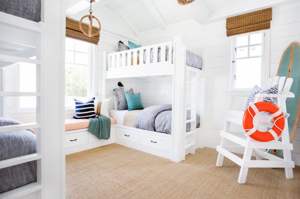 White Coastal Kids' Room With Four White Bunk Beds and Lifeguard Chair